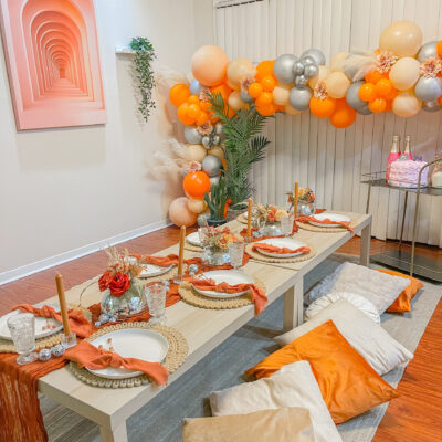 houston luxury picnic setup with orange white balloons indoor with shade on table